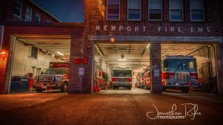 3  Fire station doors open showing apparatus -  lit from the inside